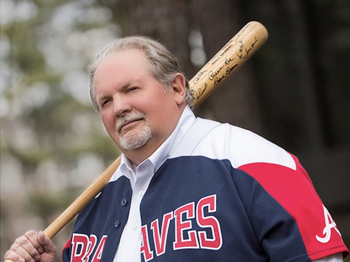 The CardFather with a signed bat over his shoulder.